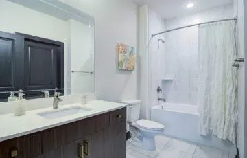 a bathroom with a sink toilet and shower