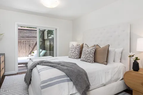 a bedroom with a bed and a lamp