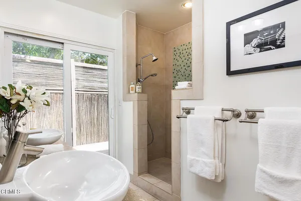 a en suite bathroom with sinks granite and a mirror
