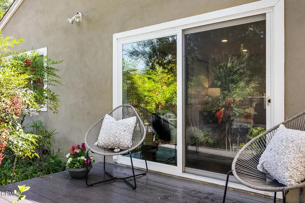 a view of a backyard with furniture and a fire pit