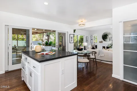 a kitchen with granite countertop white cabinets and stainless steel appliances