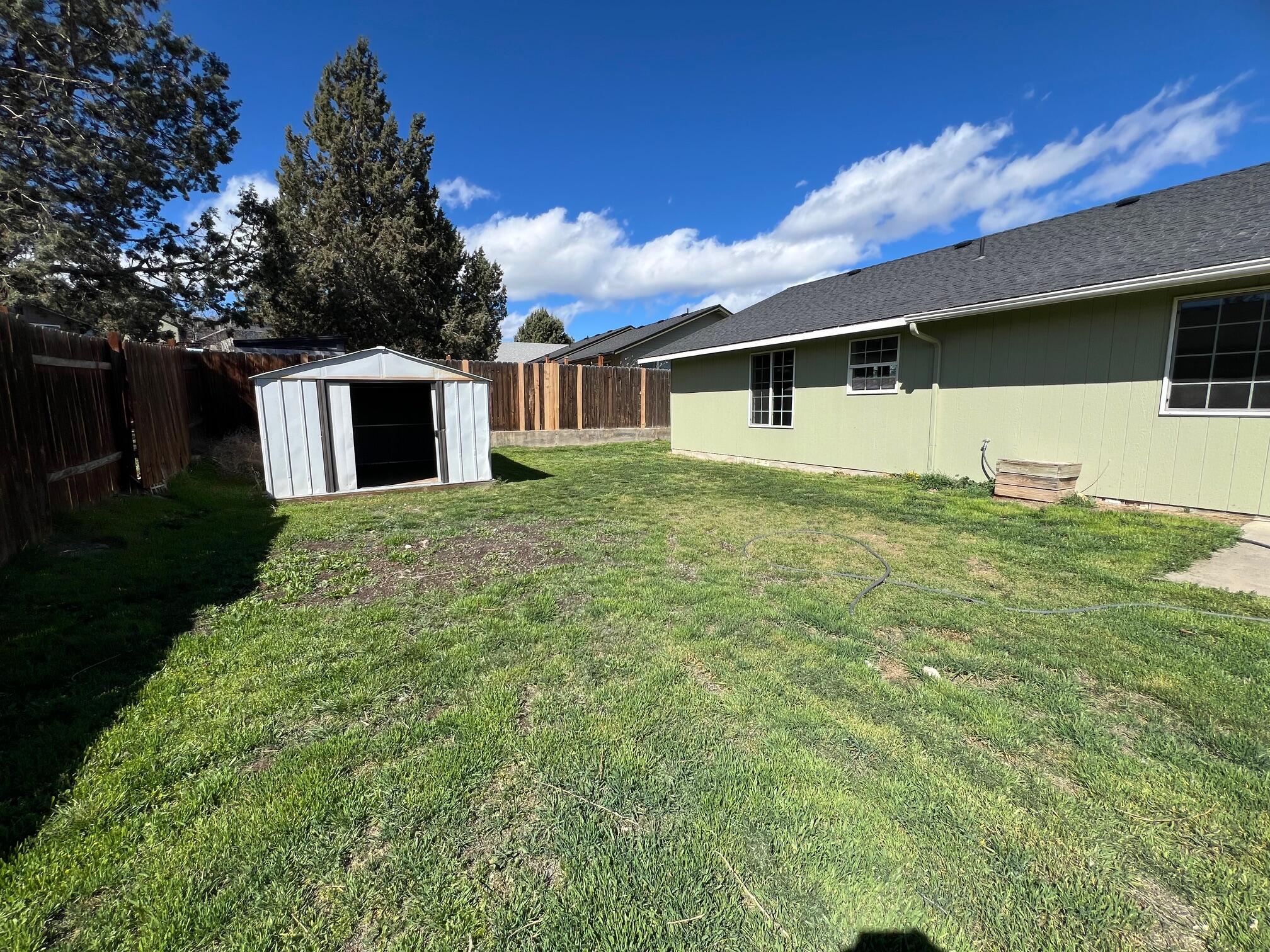 629 Deer Ridge Court Madras, OR 97741 - Photo 39 of 39 a view of a yard in front of a house with large windows