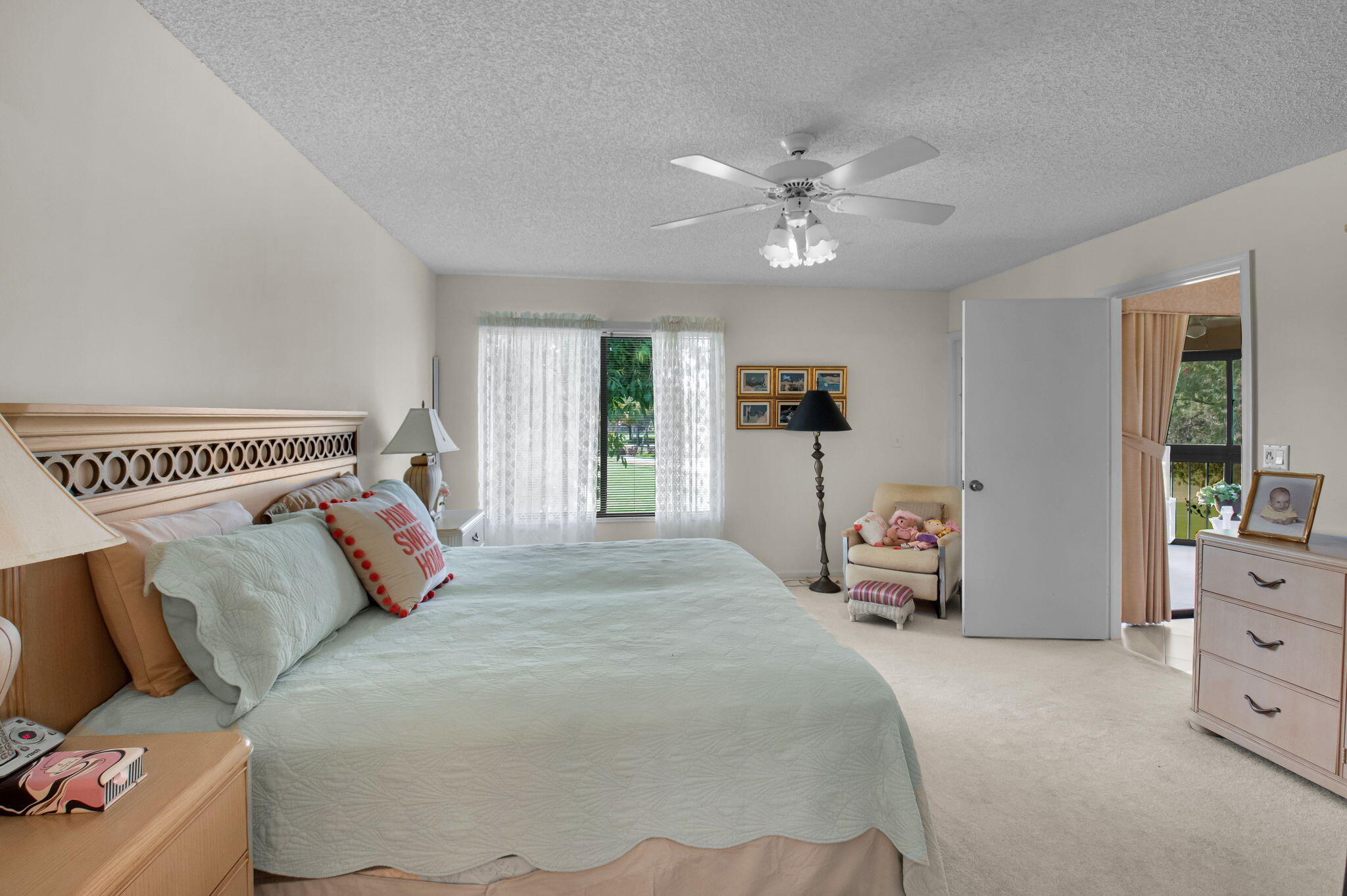 7380 Clunie Place, Unit 13006 Delray Beach, FL 33446 - Photo 13 of 67 a bedroom with a large bed and a chandelier