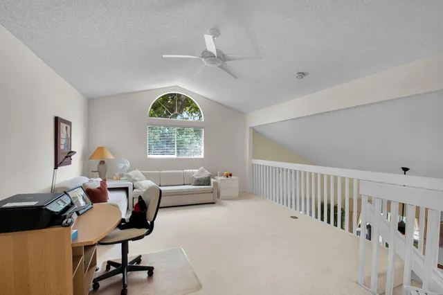 a bedroom with bed and a large window