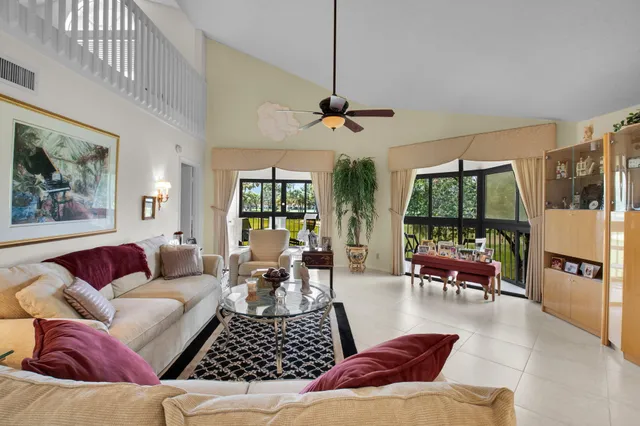 a living room with furniture ceiling fan and a window