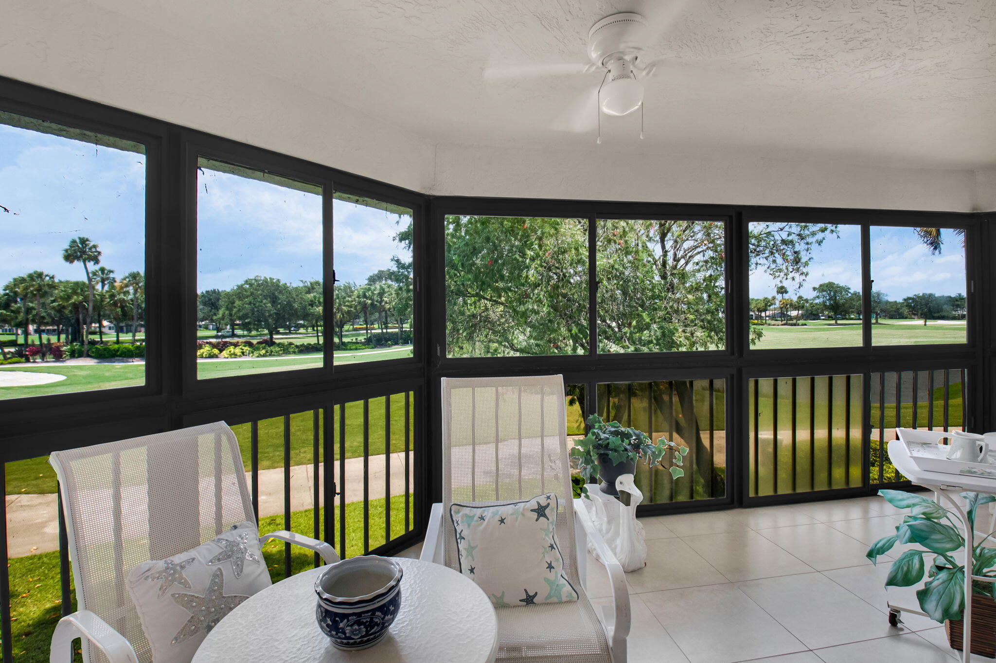 7380 Clunie Place, Unit 13006 Delray Beach, FL 33446 - Photo 26 of 67 a living room with furniture and a floor to ceiling window