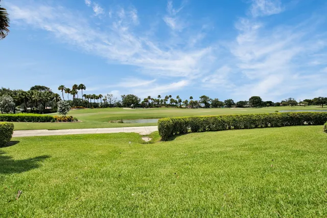 an aerial view of a house with a garden and lake view