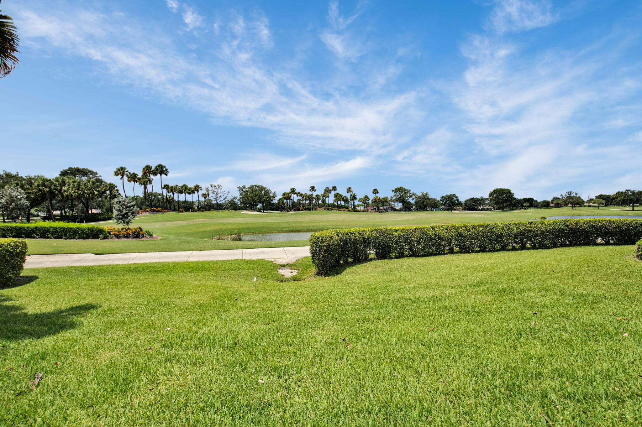 7380 Clunie Place, Unit 13006 Delray Beach, FL 33446 - Photo 29 of 67 a view of a golf course with a lake