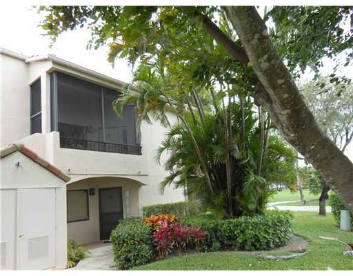 7380 Clunie Place, Unit 13006 Delray Beach, FL 33446 - Photo 32 of 67 a front view of a house with a garden