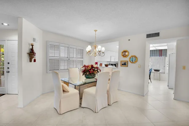 a view of a dining room with furniture and a chandelier