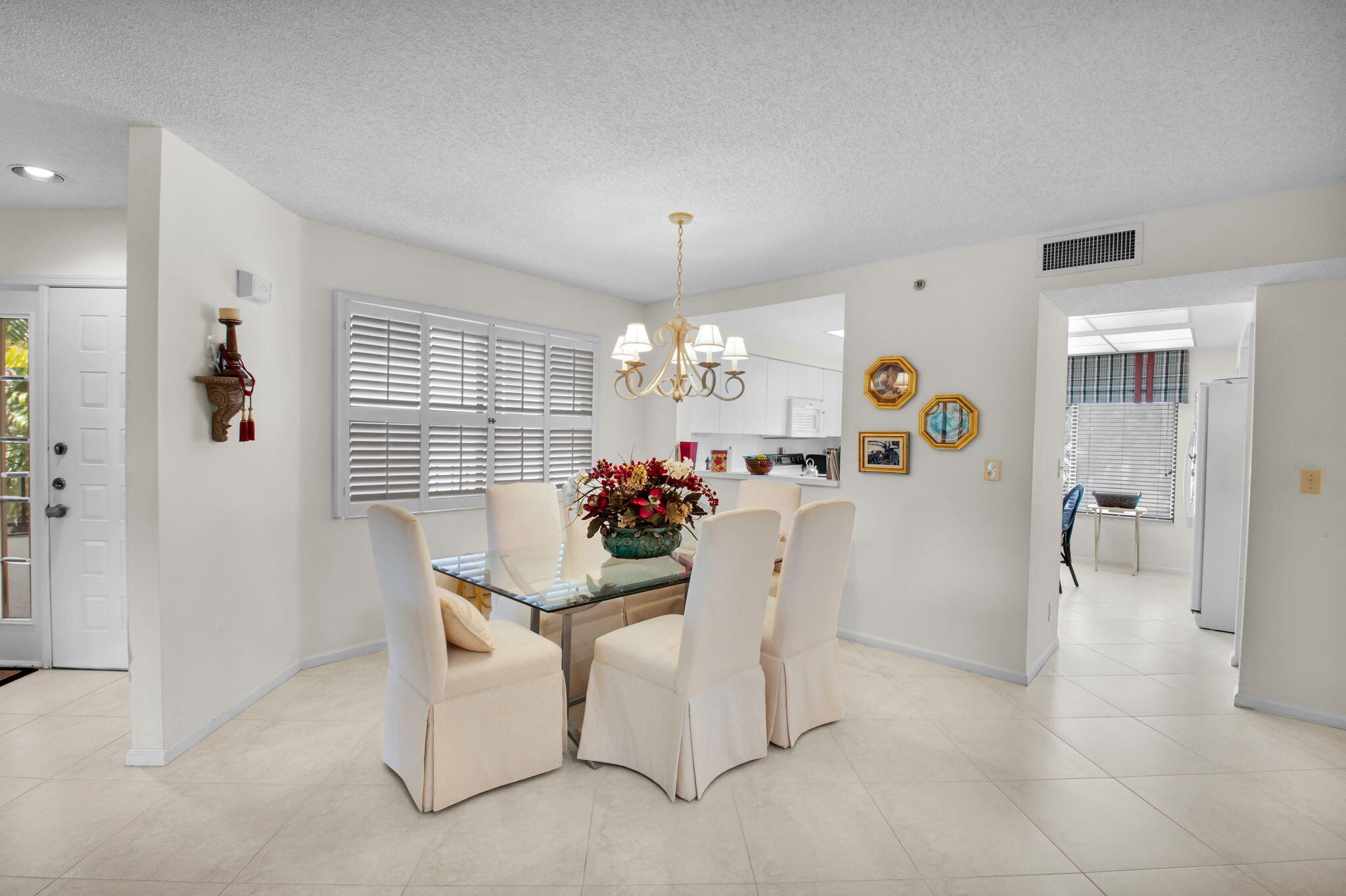 7380 Clunie Place, Unit 13006 Delray Beach, FL 33446 - Photo 4 of 67 a view of a dining room with furniture and a chandelier
