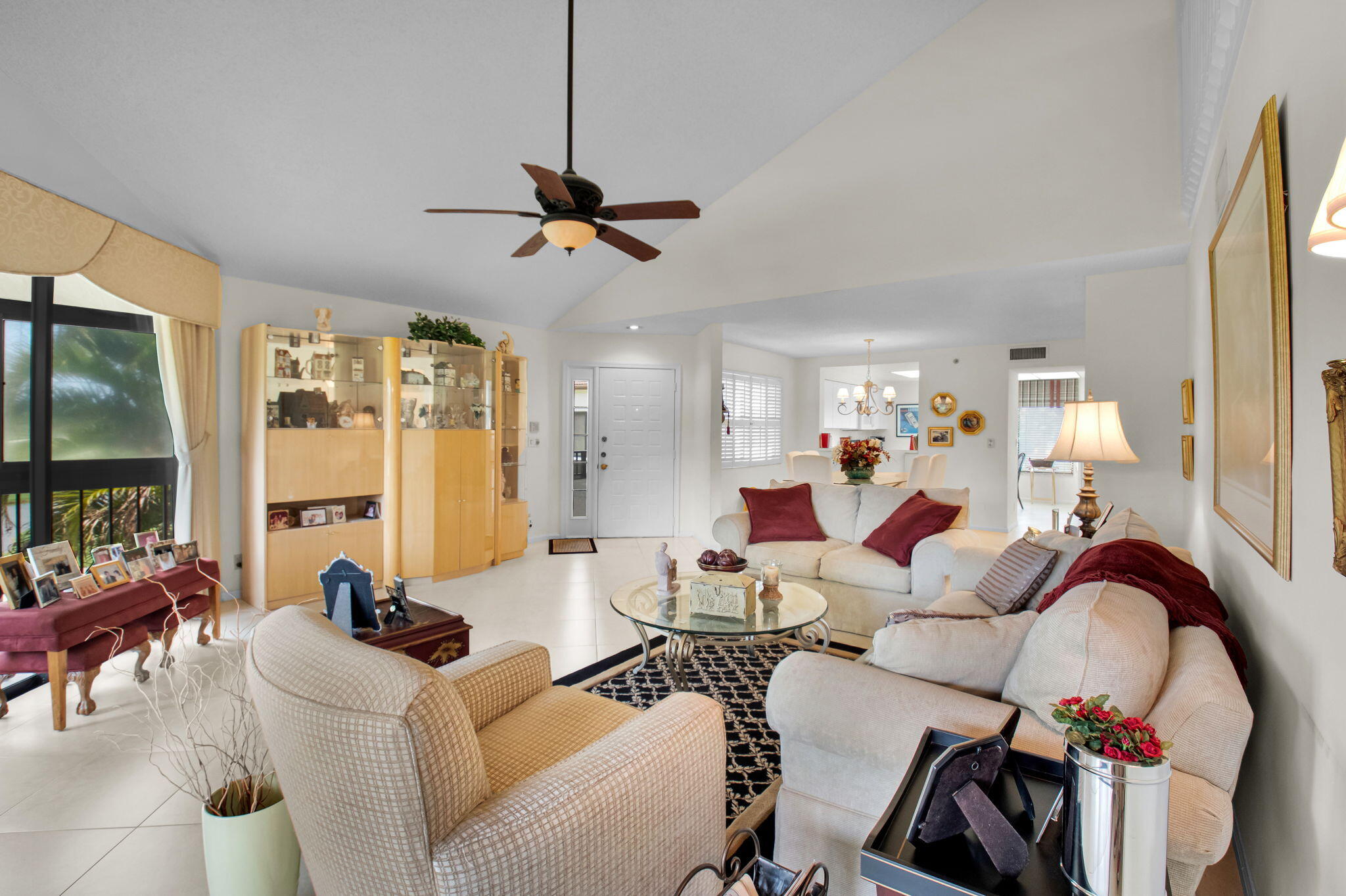 7380 Clunie Place, Unit 13006 Delray Beach, FL 33446 - Photo 5 of 67 a living room with furniture a flat screen tv and large windows