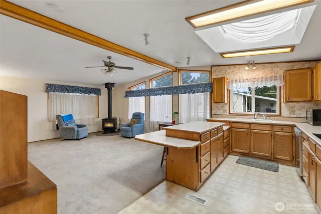 a kitchen with stainless steel appliances granite countertop a sink and a refrigerator