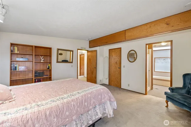 a spacious bedroom with a large bed and a window