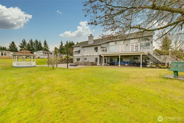 a swimming pool with outdoor seating and yard