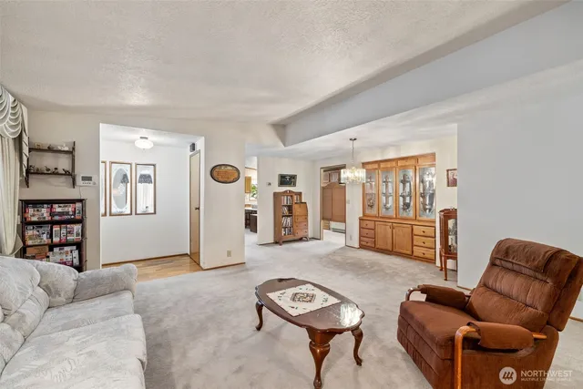 a living room with furniture a ceiling fan and a wooden floor