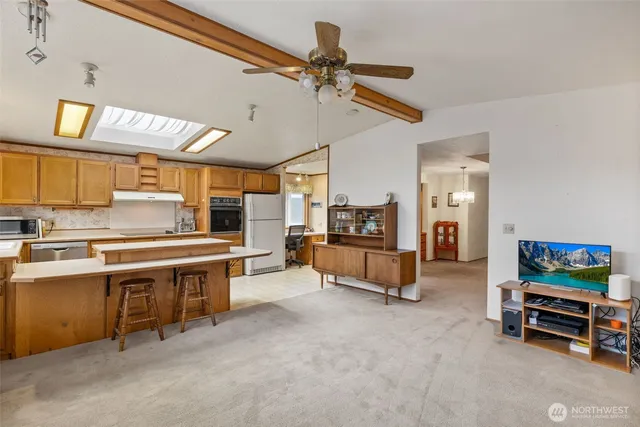 a view of a kitchen with furniture and a ceiling fan