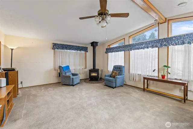 a living room with furniture gym equipment and a large window