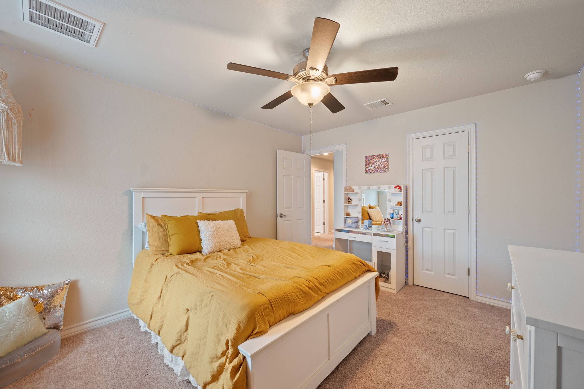 409 Limestone Road Liberty Hill, TX 78642 - Photo 25 of 35 a bedroom with a large bed and a chandelier
