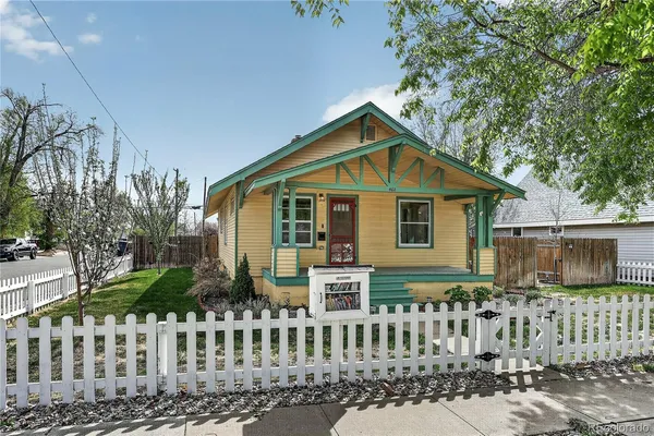 a view of a house with wooden fence