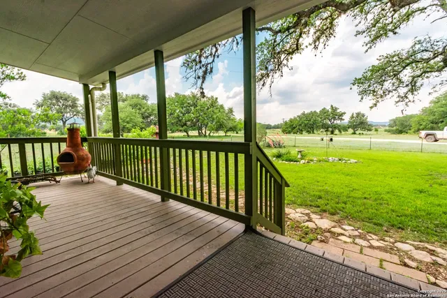 a view of balcony with wooden floor and fence