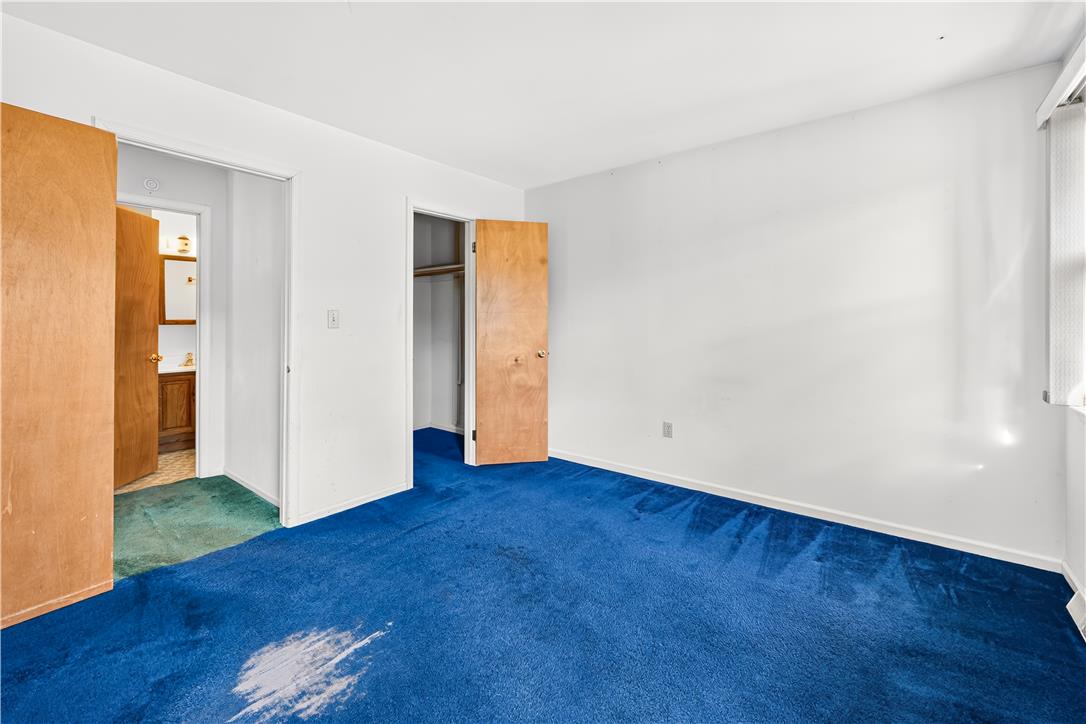 168 Springhouse Road Allentown, PA 18104 - Photo 19 of 49 A spacious bedroom presents a blank canvas for personalization with its bright blue carpeting and ample natural light.