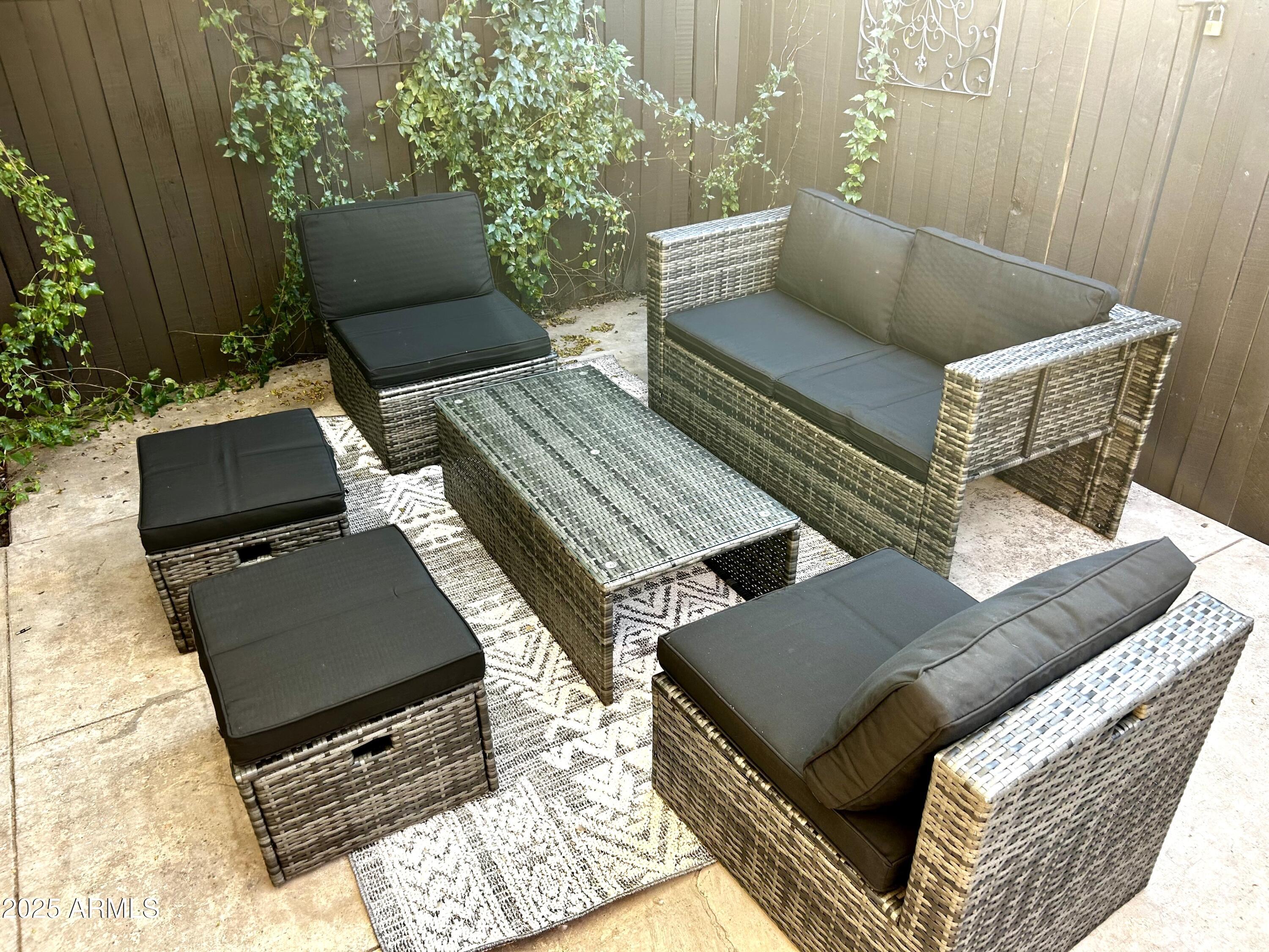 3046 North 32nd Street, Unit 333 Phoenix, AZ 85018 - Photo 15 of 16 an outdoor sitting area with furniture and wooden floor