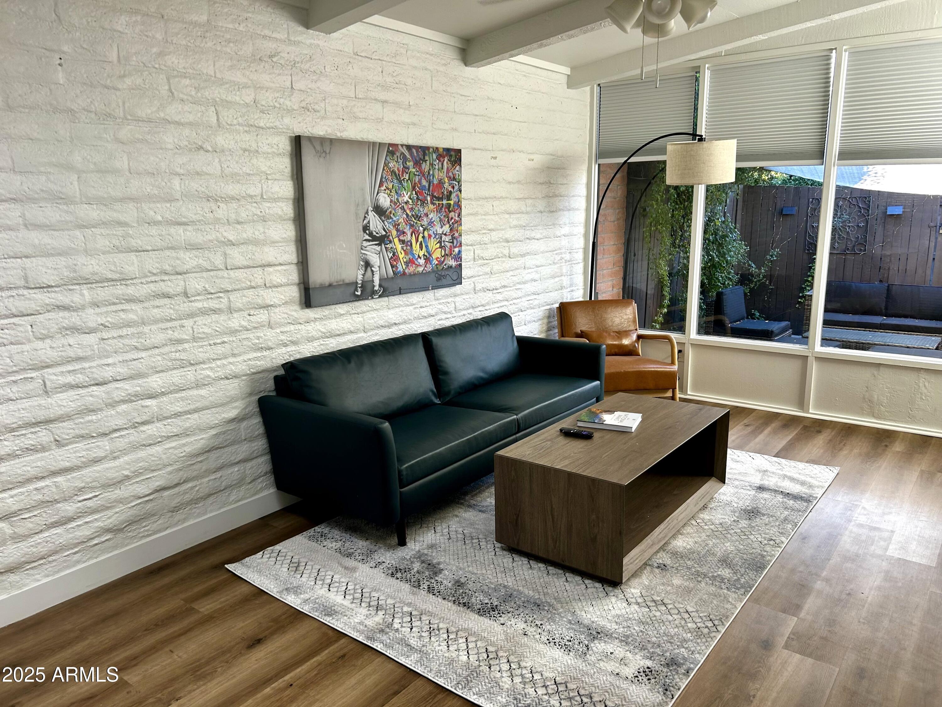 3046 North 32nd Street, Unit 333 Phoenix, AZ 85018 - Photo 2 of 16 a living room with furniture and a floor to ceiling window