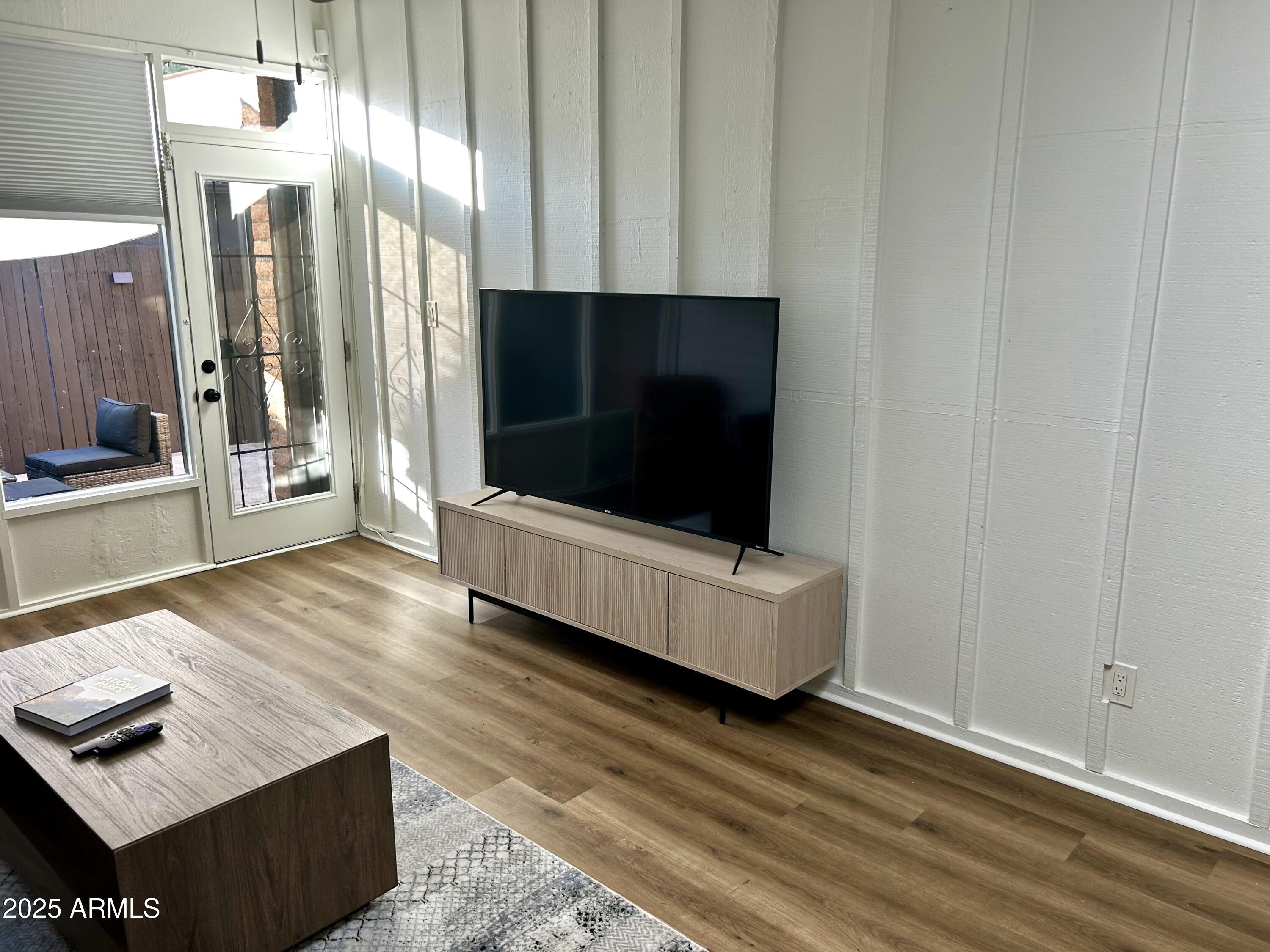 3046 North 32nd Street, Unit 333 Phoenix, AZ 85018 - Photo 3 of 16 a living room with furniture and a flat screen tv