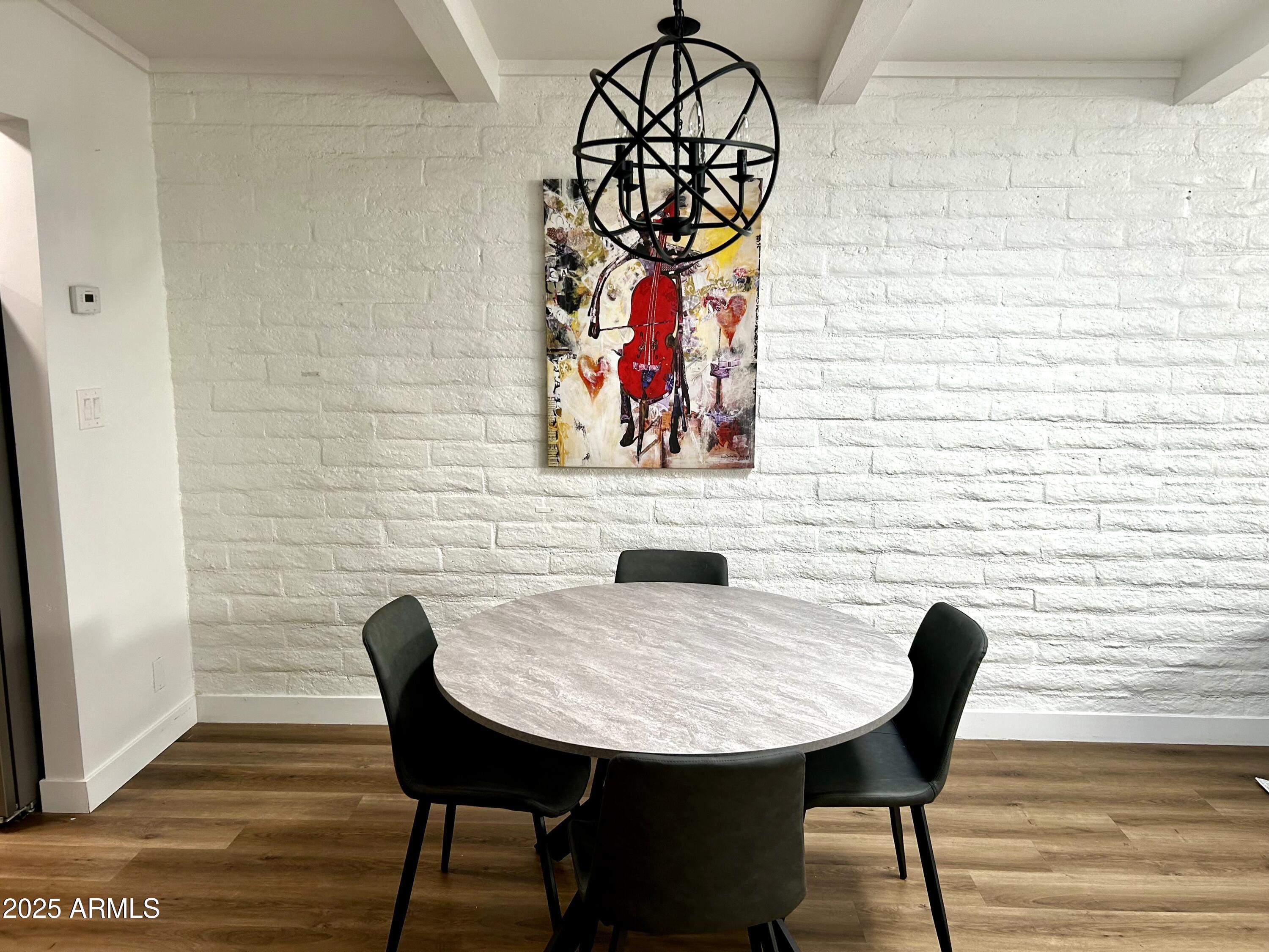 3046 North 32nd Street, Unit 333 Phoenix, AZ 85018 - Photo 6 of 16 a view of a dining room with furniture and wooden floor