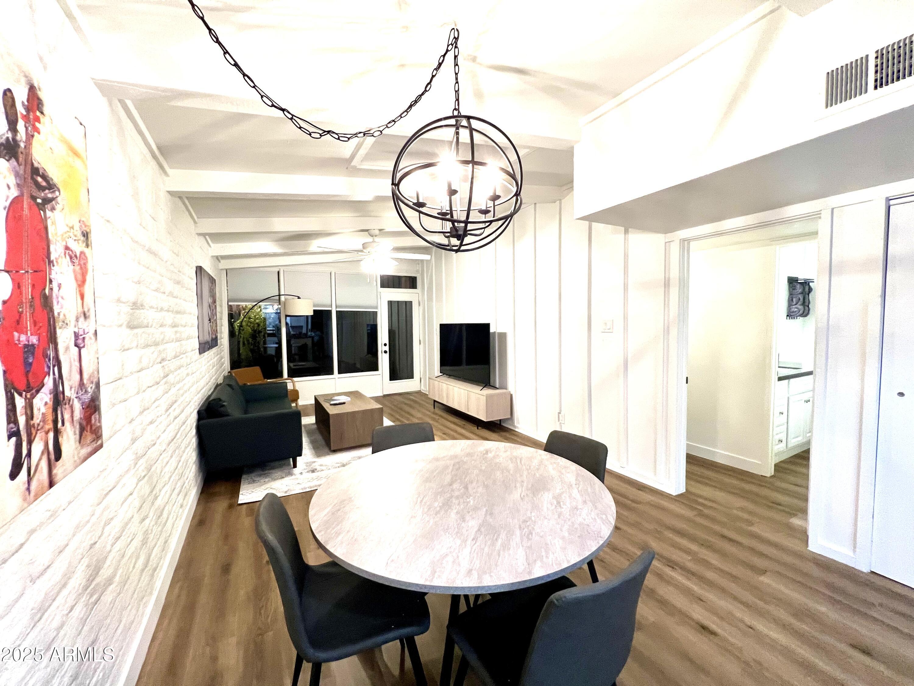 3046 North 32nd Street, Unit 333 Phoenix, AZ 85018 - Photo 7 of 16 a living room with furniture a fireplace and a floor to ceiling window