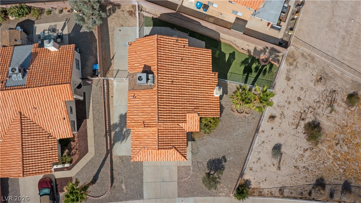 3156 Terrace View Drive Laughlin, NV 89029 - Photo 92 of 94 An aerial perspective showcases the home's distinctive tile roof and spacious lot, offering a blend of developed and natural landscaping.