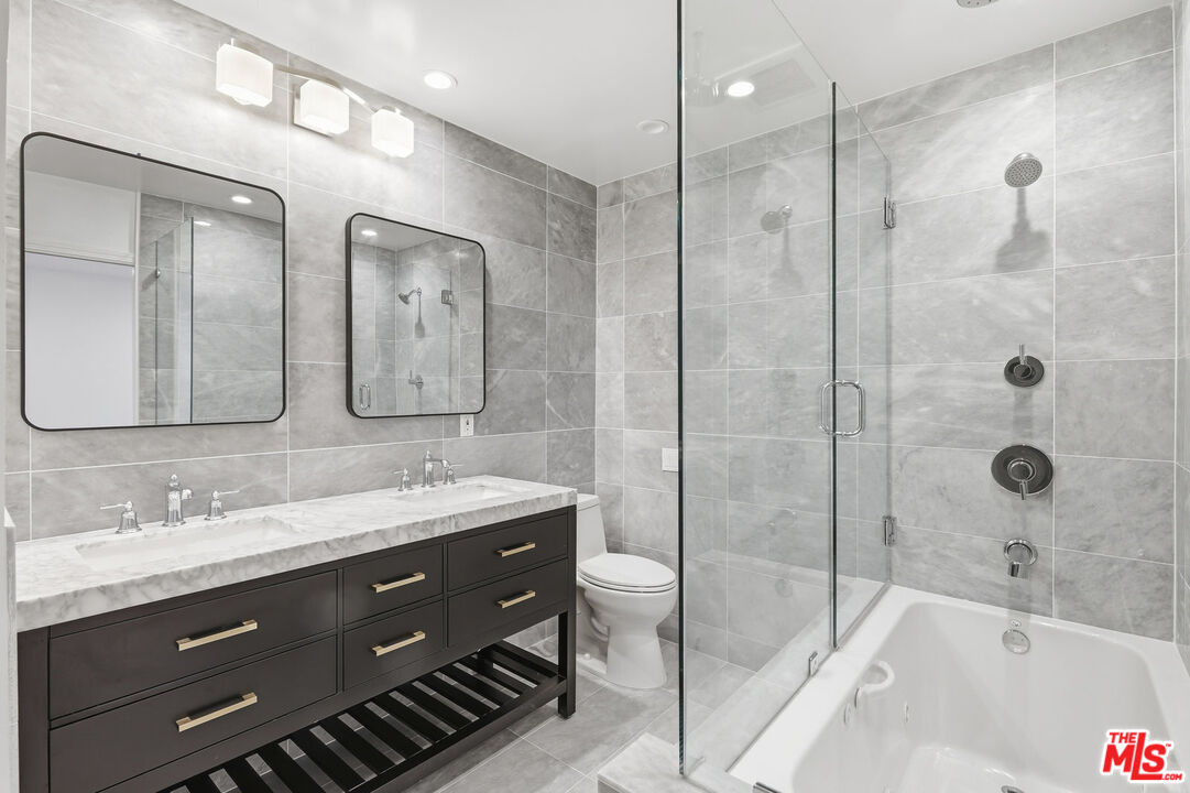 2442 South Coast Highway, Unit 4 Laguna Beach, CA 92651 - Photo 13 of 22 a bathroom with a double vanity sink mirror double and bathtub