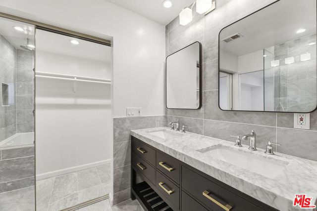 a bathroom with a granite countertop sink mirror and double
