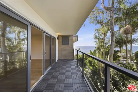 a view of balcony with wooden floor