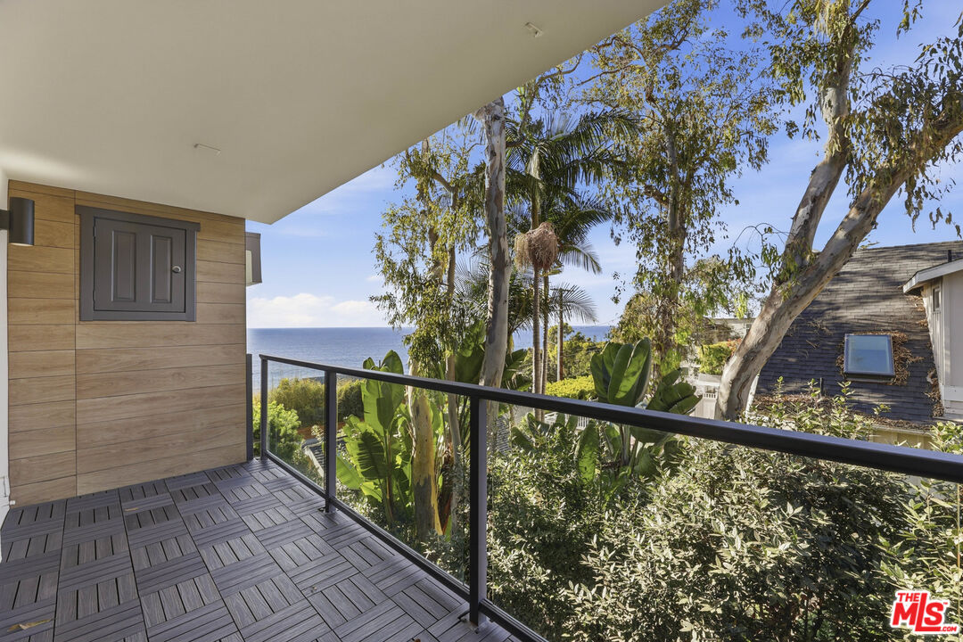 2442 South Coast Highway, Unit 4 Laguna Beach, CA 92651 - Photo 8 of 22 a view of a balcony with wooden floor