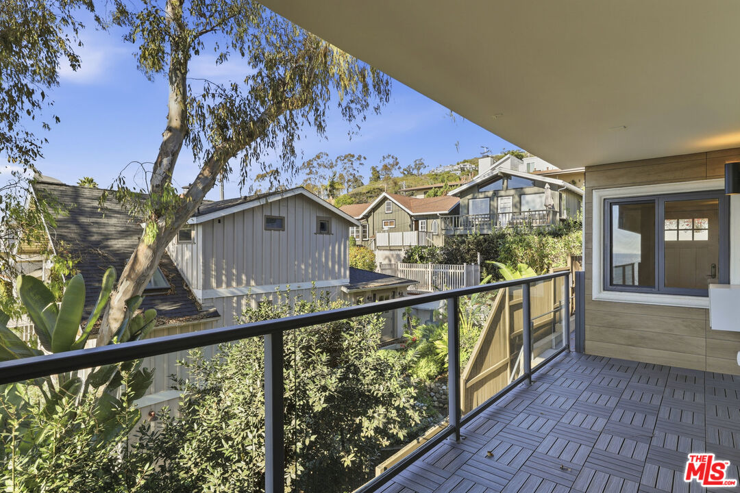 2442 South Coast Highway, Unit 4 Laguna Beach, CA 92651 - Photo 9 of 22 a view of a balcony with wooden floor and fence