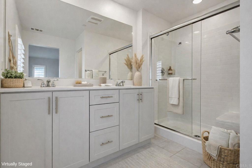 35131 Rangpur Lane Fallbrook, CA 92028 - Photo 17 of 61 a bathroom with a double vanity sink mirror and shower