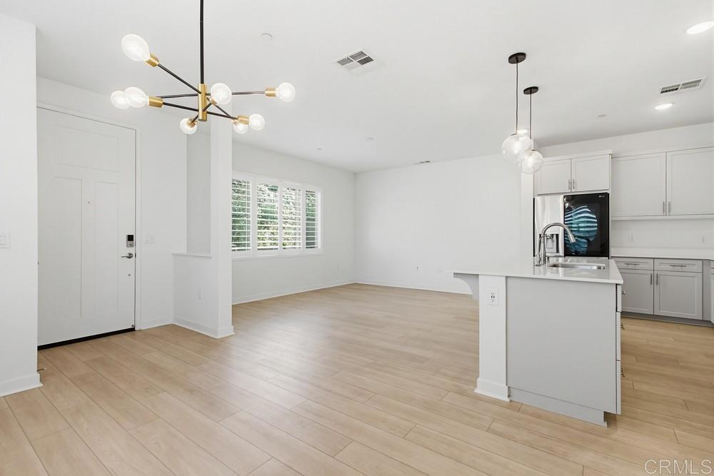 35131 Rangpur Lane Fallbrook, CA 92028 - Photo 18 of 61 a view of an empty room with a window and wooden floor