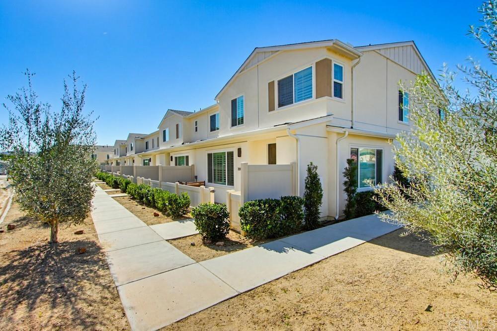 35131 Rangpur Lane Fallbrook, CA 92028 - Photo 2 of 61 a view of a white house with a yard and potted plants