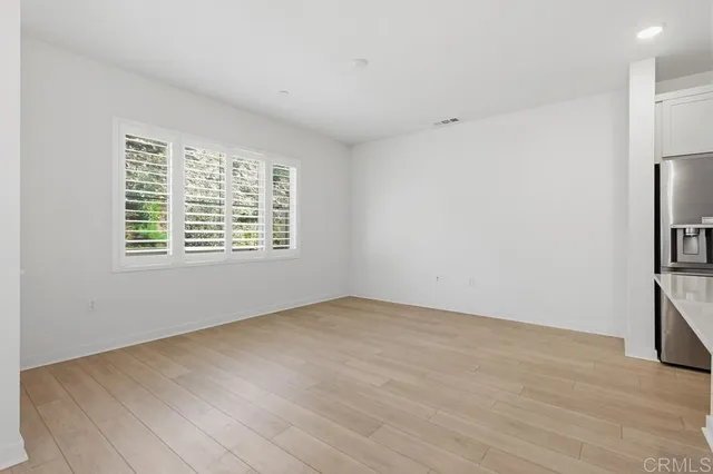 a view of kitchen with kitchen island a sink stainless steel appliances and cabinets