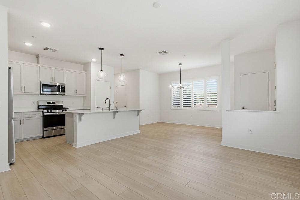 35131 Rangpur Lane Fallbrook, CA 92028 - Photo 25 of 61 a view of kitchen with kitchen island a sink stainless steel appliances and cabinets
