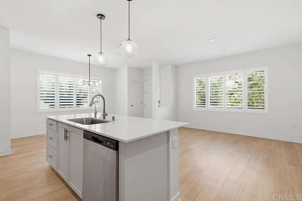 35131 Rangpur Lane Fallbrook, CA 92028 - Photo 29 of 61 a kitchen with stainless steel appliances granite countertop a sink a window and wooden floor