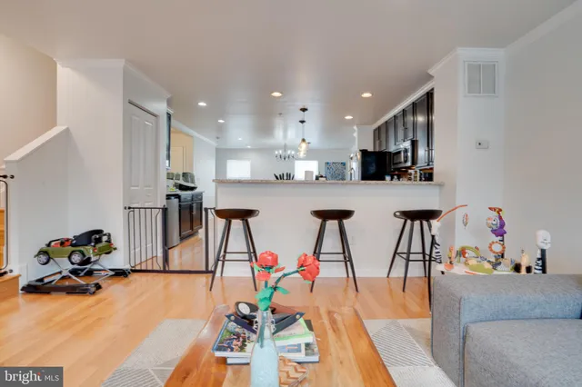 a living room with lots of furniture and a view of kitchen