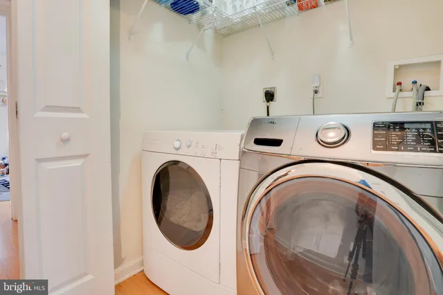 a bedroom with a bed a window and a flat screen television