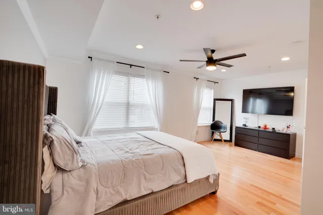 a bedroom with a bed window and a chair