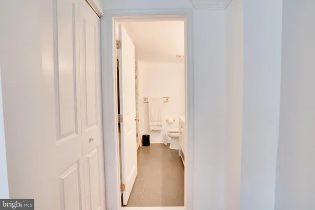 a bathroom with a granite countertop sink a toilet and shower