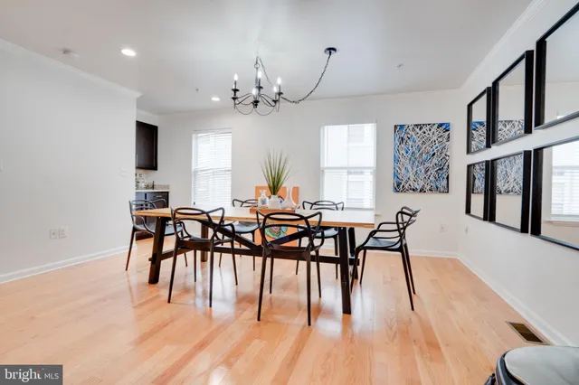 a view of a dining room with furniture and chandelier