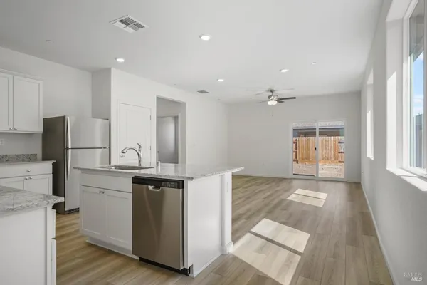 a view of kitchen with wooden floor and electronic appliances