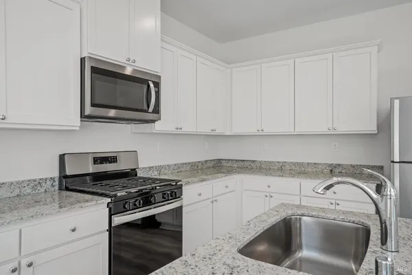 a kitchen with a sink stove and microwave